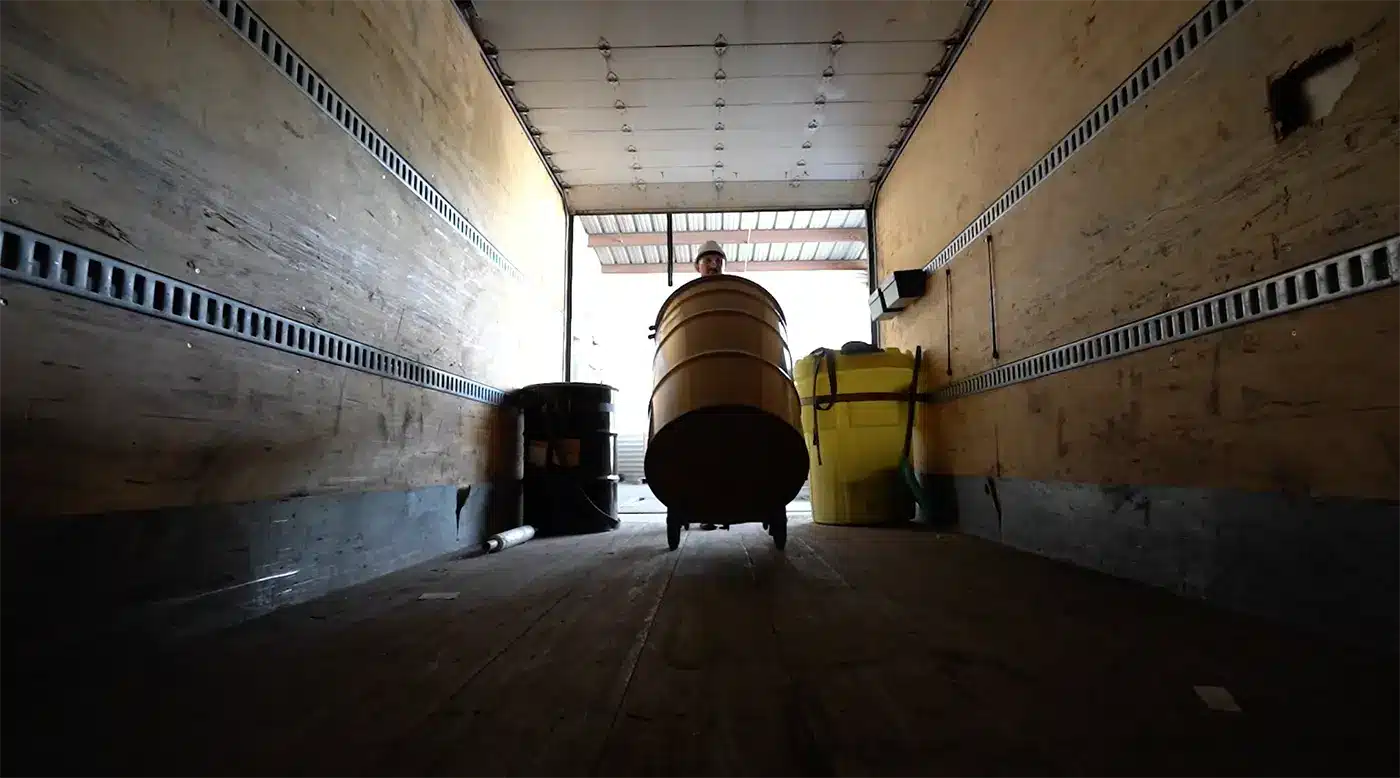 Drums loaded onto a Greer truck for scheduled pickup.